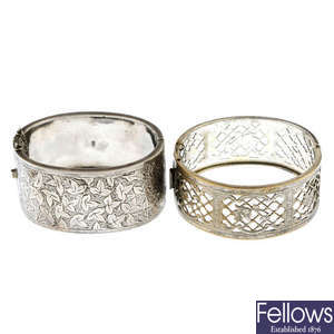 A late Victorian silver hinged bangle together with a silver plated bangle.