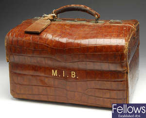A turn of the century crocodile skin gladstone style gentleman's travelling vanity bag & contents.