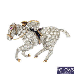 A mid 20th century diamond and synthetic ruby racing horse brooch.