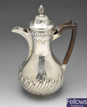 A George II silver hot water pot.
