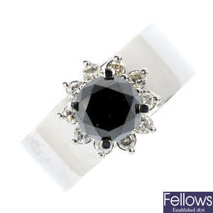 A black gem and diamond floral cluster ring.