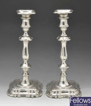 An Edwardian pair of silver candlesticks.
