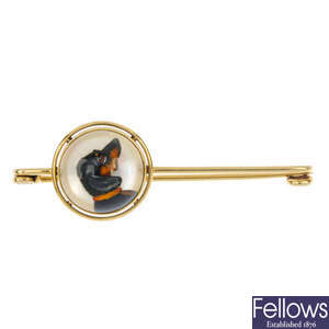 An early 20th century gold reverse carved intaglio Dachshund bar brooch.