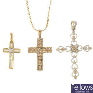 A selection of three diamond cross pendants.