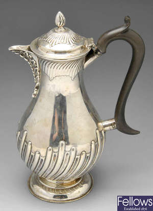 A Victorian silver hot water pot.