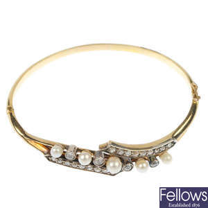 An early 20th century 18ct gold and silver diamond and cultured pearl bangle.