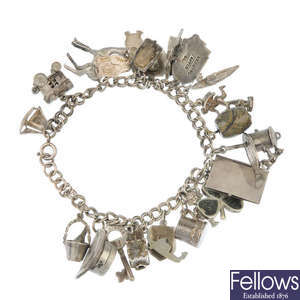 Four silver and white metal charm bracelets.