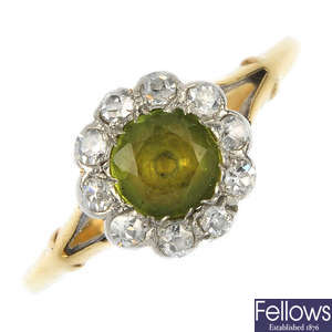 An early 20th century gold peridot and diamond cluster ring.