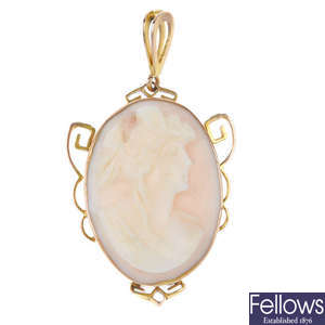 A cameo pendant and a pair of cameo ear pendants.