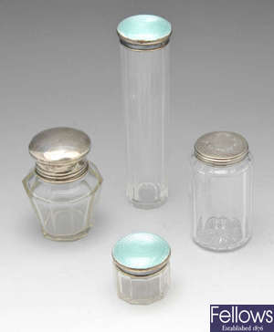 A selection of Victorian and later silver topped glass vanity jars.