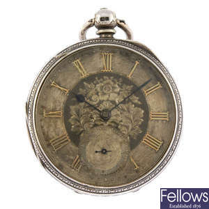 An open face pocket watch by Paul Hughes with two other pocket watches.