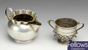 A Victorian silver cream jug & a 1920's miniature silver trophy cup.