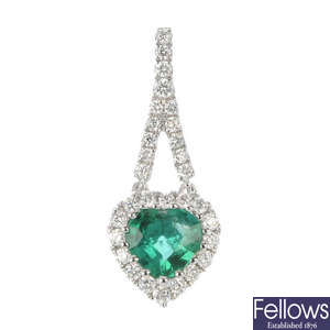 An emerald and diamond cluster pendant.