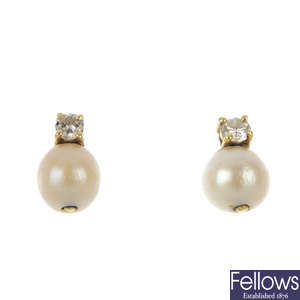 A pair of diamond and cultured pearl ear studs.