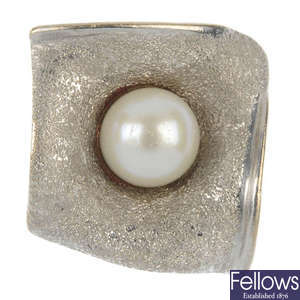 A cultured pearl floral dress ring.
