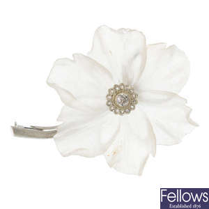 A diamond and glass floral brooch.