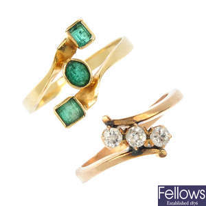 Two diamond and emerald rings.