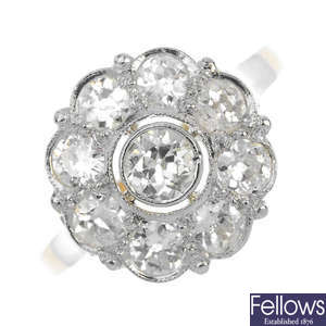 A mid 20th century silver and 14ct gold diamond floral cluster ring.