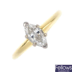 A gold diamond single-stone ring.