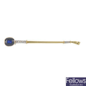 A mid 20th century sapphire and diamond riding crop brooch.