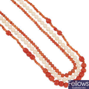 Two coral necklaces and a mother-of-pearl necklace.