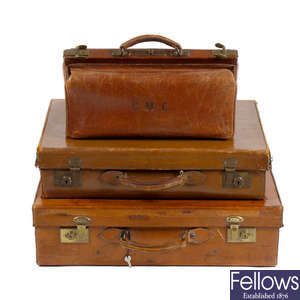 Three leather luggage cases.