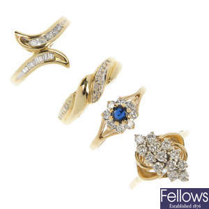 A selection of four gold diamond and gem-set rings.