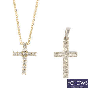 Two gold diamond cross pendants.
