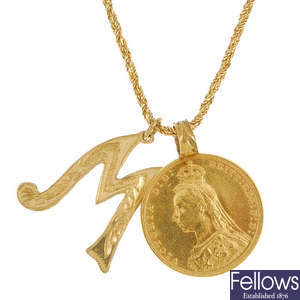 A full sovereign pendant and 9ct gold initial pendant.