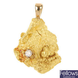 A diamond and gold nugget pendant.