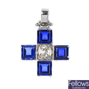 A diamond and synthetic sapphire cross pendant.
