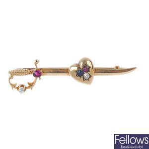 An early 20th century 9ct gold gem-set heart and sword brooch.