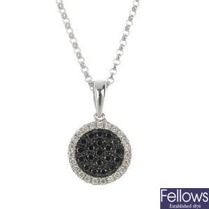 An 18ct gold diamond and black gem pendant with ear studs.
