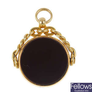 A late 19th century 18ct gold hardstone swivel fob. 
