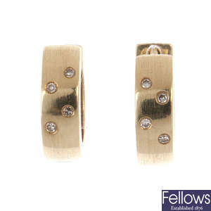 Two pairs of gold and diamond ear hoops.