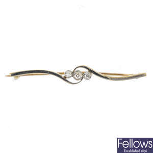 An early 20th century gold and diamond bar brooch.