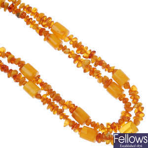 A natural amber bead necklace of barrel and freeform beads.
