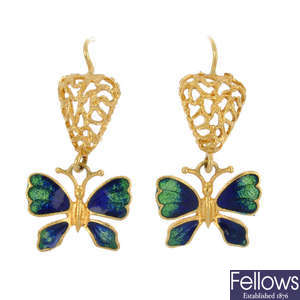 A pair of enamel butterfly ear pendants and a necklace cord.