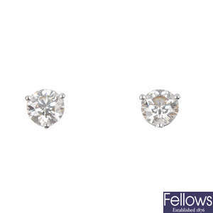 A pair of brilliant-cut diamond single-stone ear studs. 