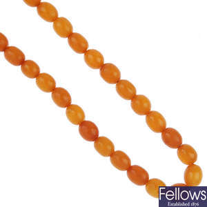 A natural amber bead necklace and a pair of natural amber earrings.