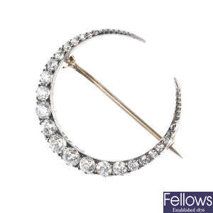 A late 19th century silver and 9ct gold diamond crescent brooch.