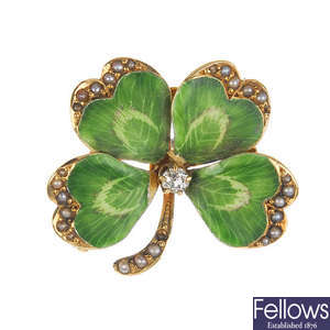 An early 20th century gold enamel, diamond and seed pearl four-leaf clover brooch.