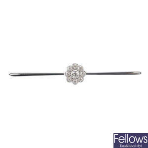 An early 20th century platinum and 18ct gold diamond cluster bar brooch.