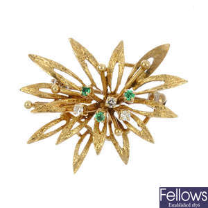 An emerald and diamond foliate brooch.