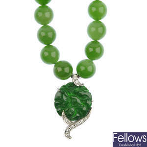 A nephrite jade necklace with jade and diamond pendant.