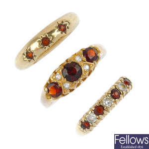 A collection of three 9ct gold garnet rings.