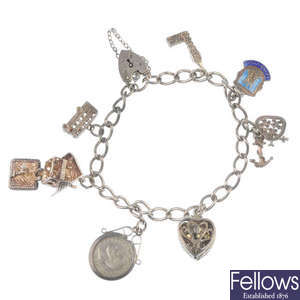 A charm bracelet and various loose charms.