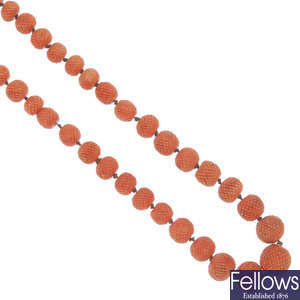 A late 19th century carved coral bead necklace.