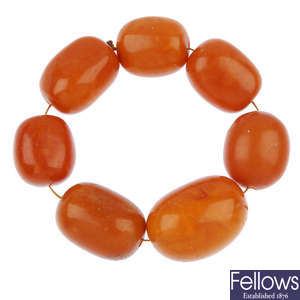 A string of seven natural amber beads.