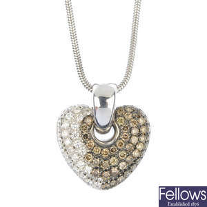A diamond and 'brown' diamond heart pendant.